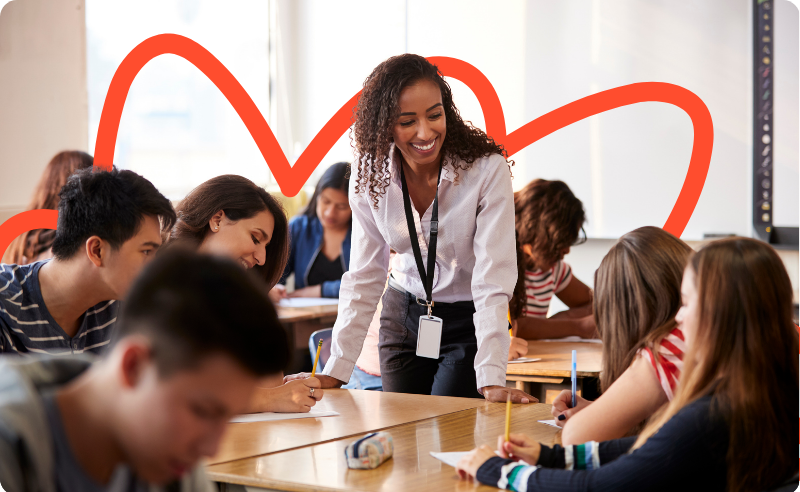 Secondary school teacher in class, smiling at pupils